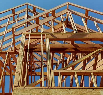 New wood roof trusses framed against a clear blue Tennessee sky